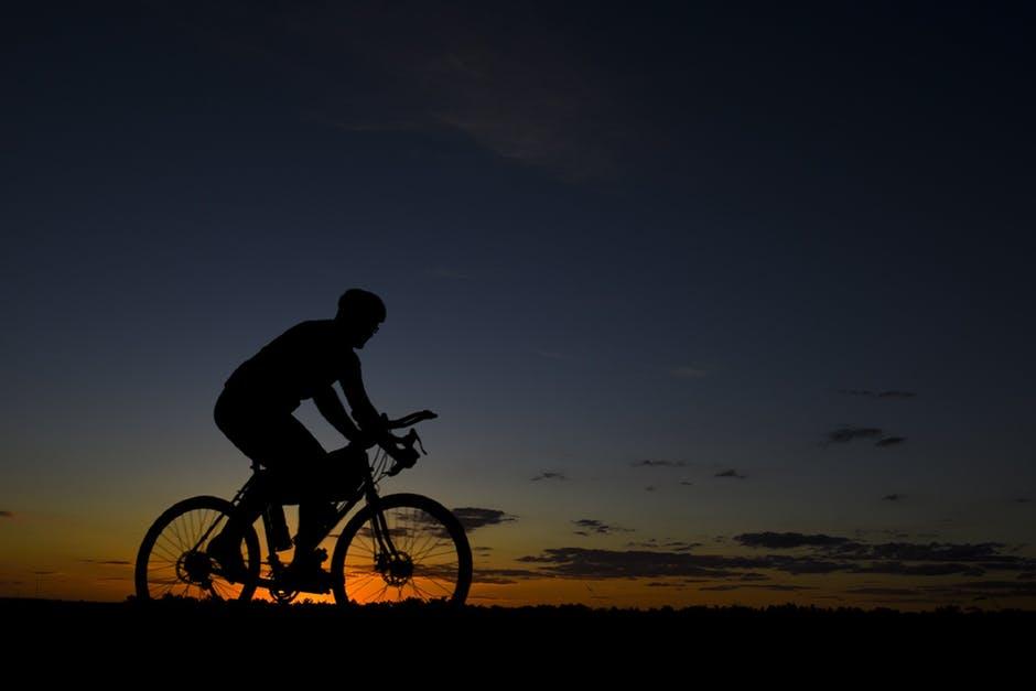 Man with bike during Nightfall